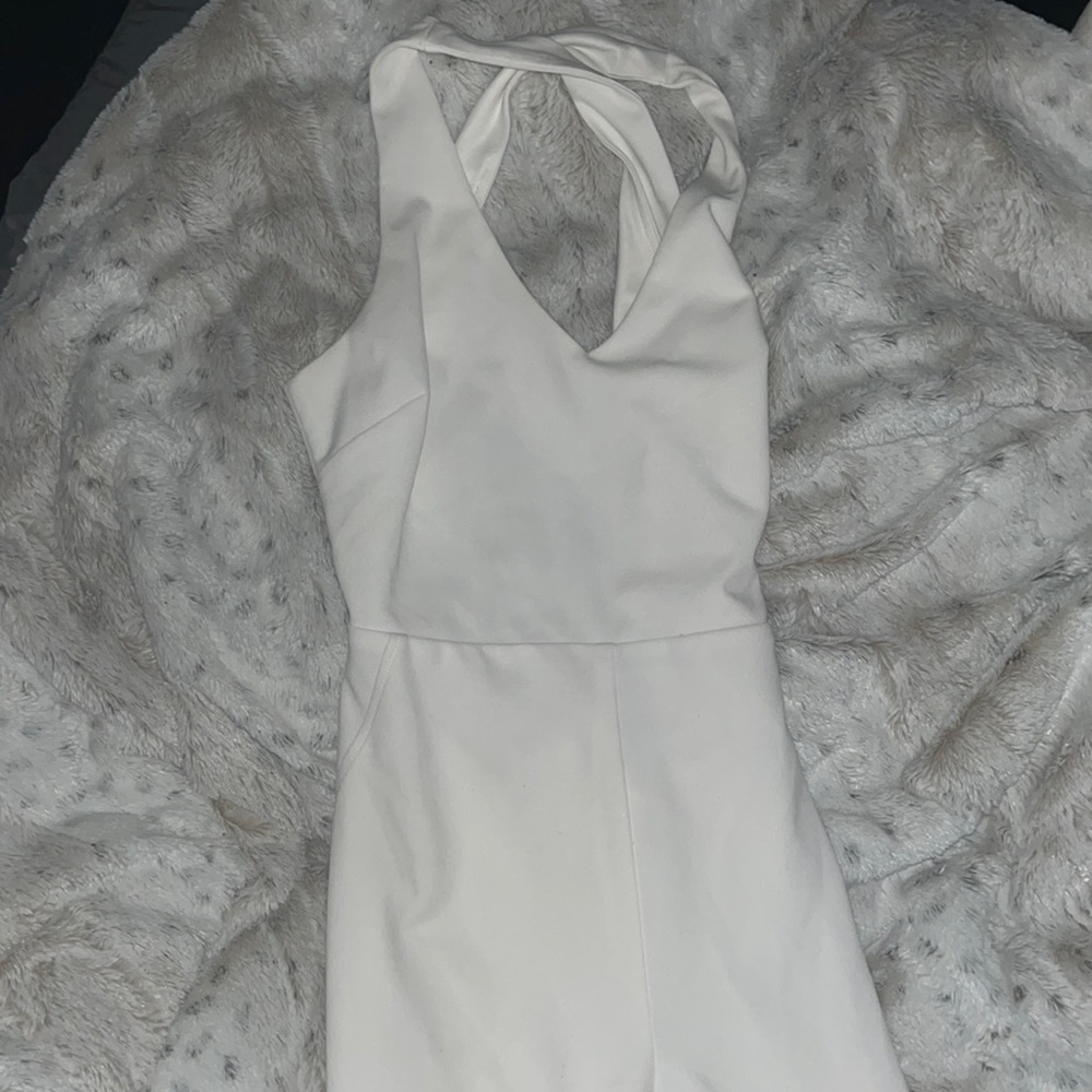 (M) All white criss cross body suit.